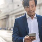 Physician reading on his phone about where patients find doctors online