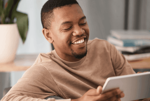 Man looking at tablet learning about website design for medical practices.