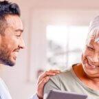 Physician smiling and speaking with patient about patient satisfaction scores