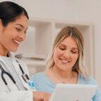 Physician shows patient survey on tablet to measure patient engagement