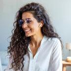 Medical practice manager smiles while reading about medical coding updates 2025 on computer