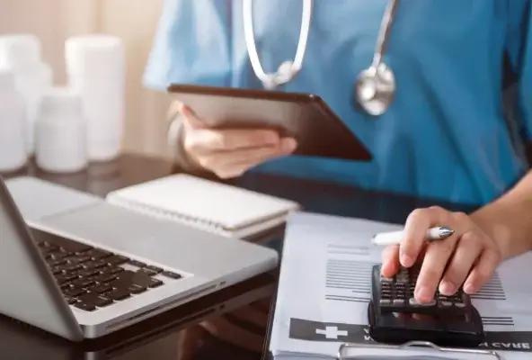 hand of medical professional using calculator