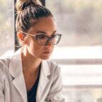 Independent practice physician reads news about Trump healthcare policy on computer