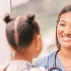 Physician smiles at patient after practice implements April healthcare marketing ideas