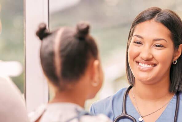 Physician smiles at patient after practice implements April healthcare marketing ideas