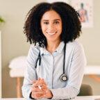 Physician smiles after reading about HIPAA cybersecurity resources