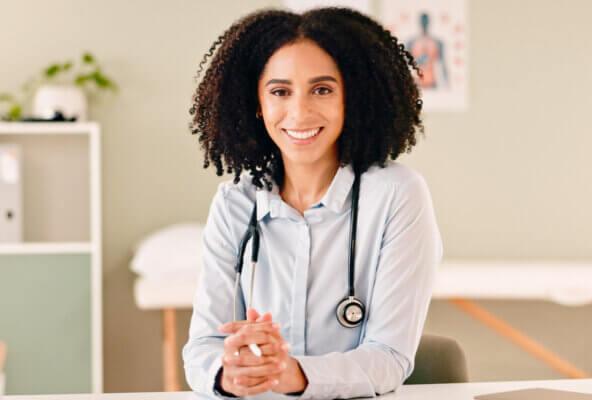 Physician smiles after reading about HIPAA cybersecurity resources