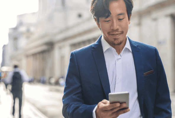 Physician reading on his phone about where patients find doctors online