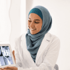 Physician ponders healthcare practice growth while working with a patient