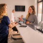 front-office staff collecting patient payment at time of service