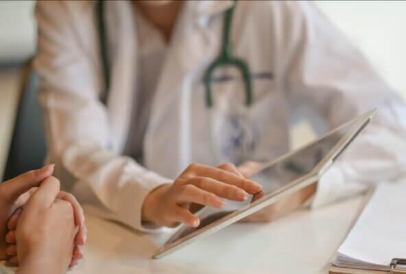 physician using tech to provide patient care