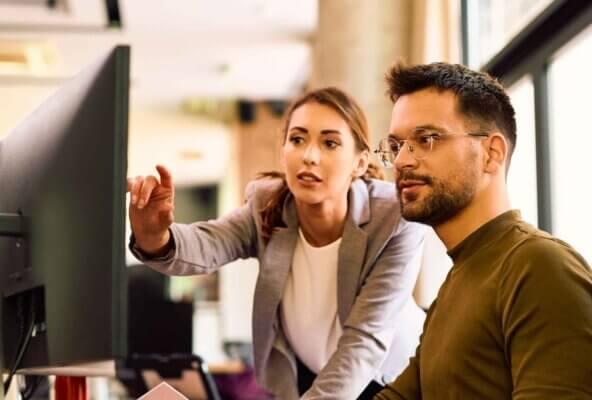 Medical practice staff members looking at computer screen discussing Google ads for medical practice