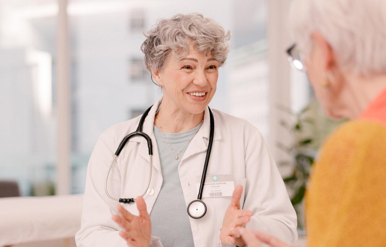 Physician talks with patient as part of February healthcare marketing ideas
