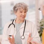 Physician talks with patient as part of February healthcare marketing ideas