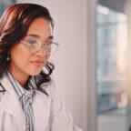 Physicians reads March revenue cycle management healthcare news on computer