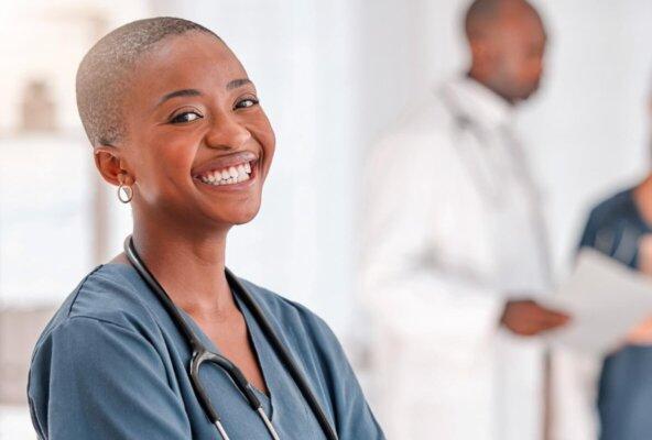 smiling doctor who uses AI medical scribe transcription