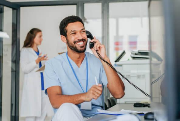 Medical practice manager answers patient billing and insurance questions on phone