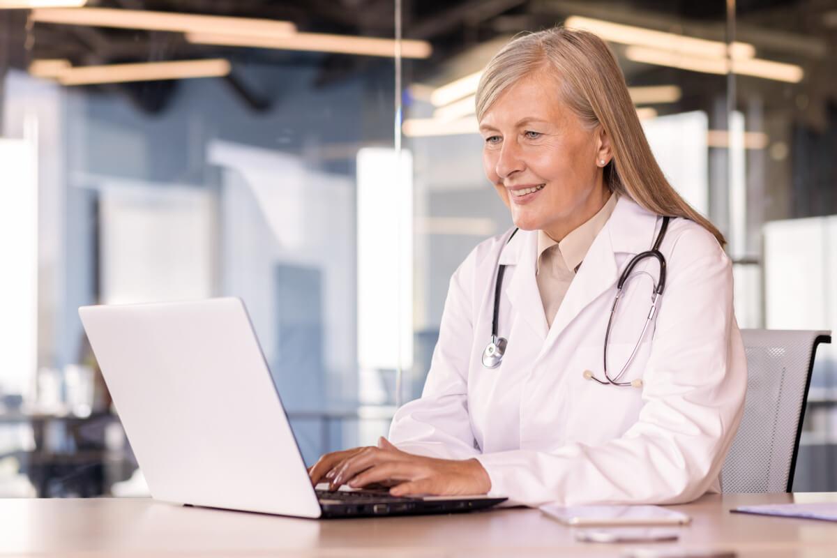 Physician reads February 2026 healthcare RCM news on computer